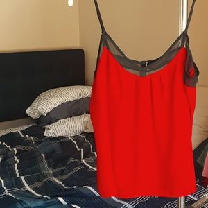 A red top with  sheer black detail sz L